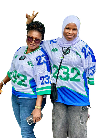 Two women wearing matching jerseys with numbers 232 and 232 on a white background