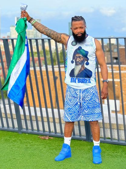 Person holding a flag with a scenic background with a sierra Leone Hero printed on the sleeveless 
