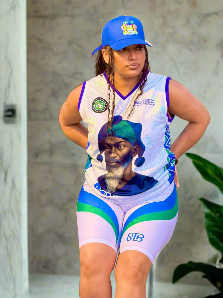 Person wearing a sports outfit with a graphic design, standing indoors.