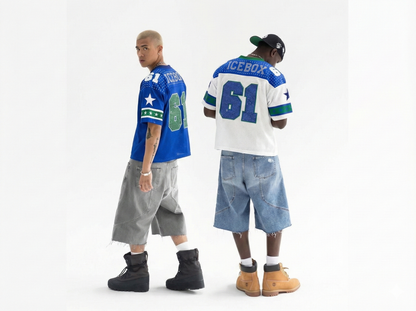 Two people wearing sports jerseys and shorts on a white background
