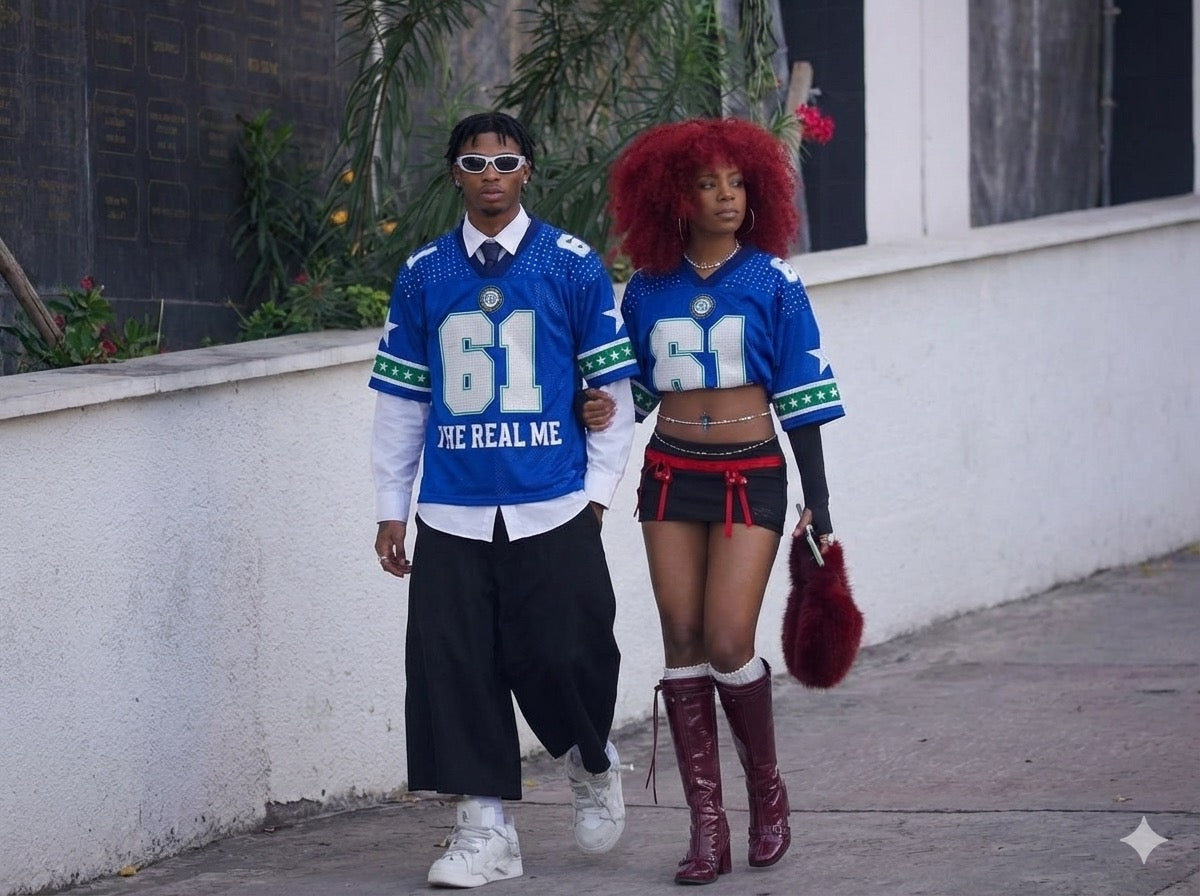 Two people wearing matching blue sports jerseys with number 61 and text, standing outdoors.