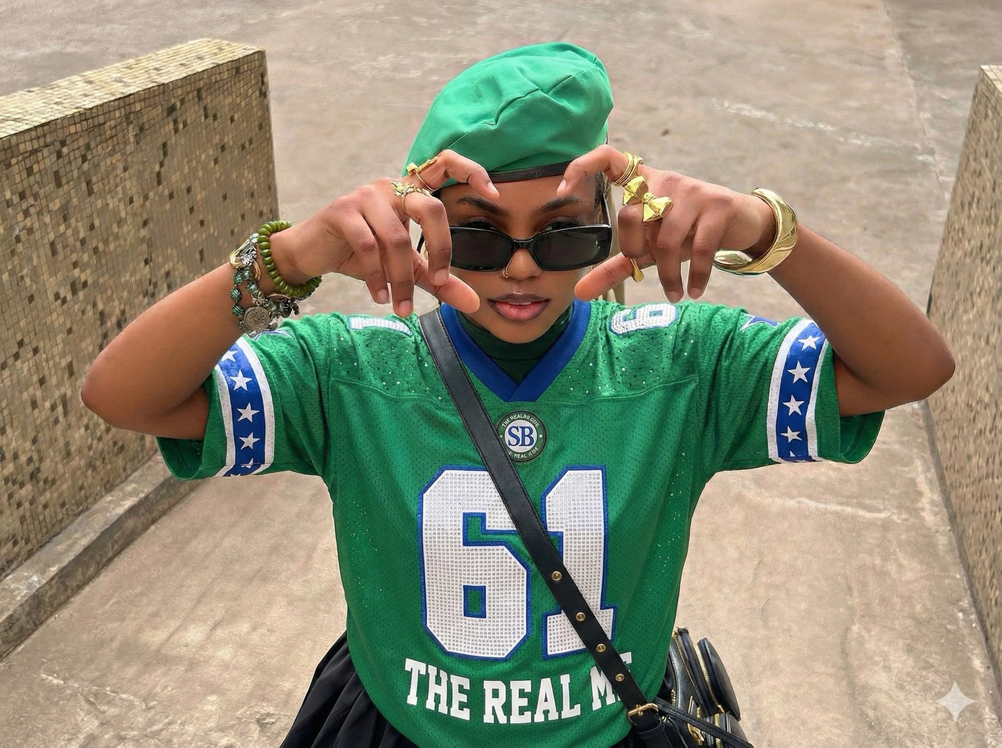 Person wearing a green sports jersey with number 61, posing outdoors.