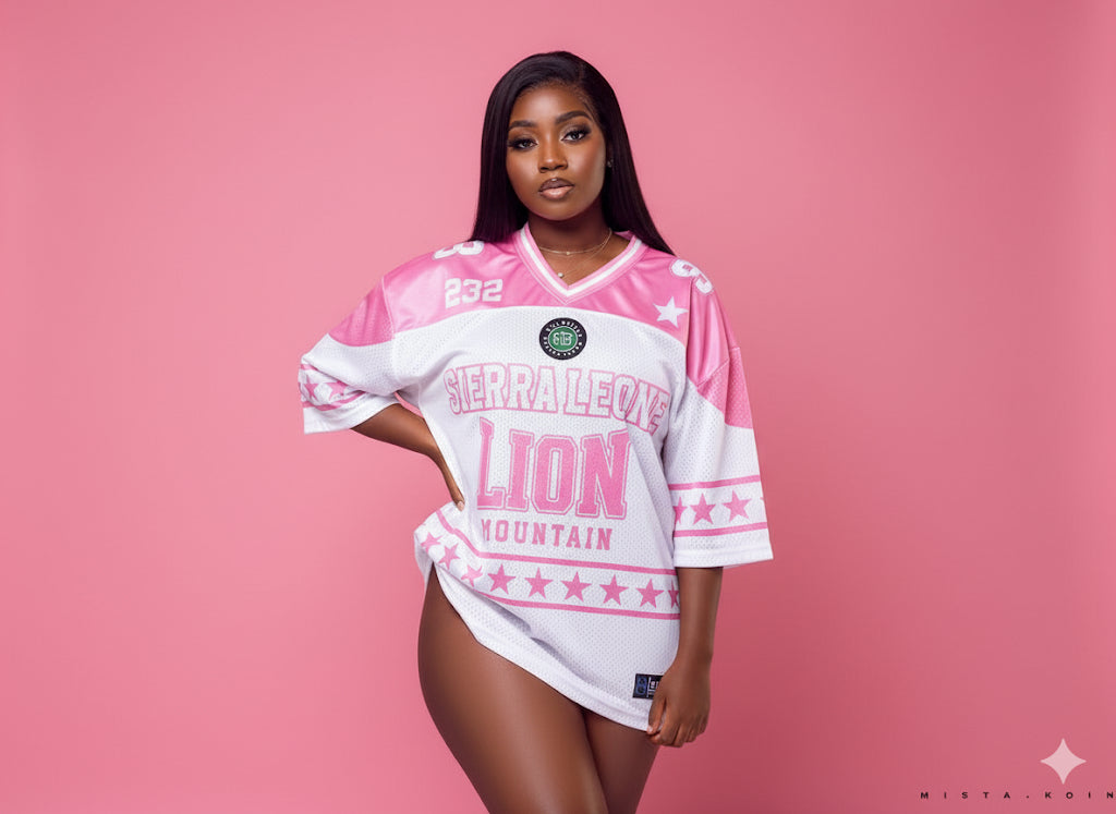Woman wearing a pink and white sports jersey with text on a pink background