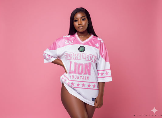 Woman wearing a pink and white sports jersey with text on a pink background