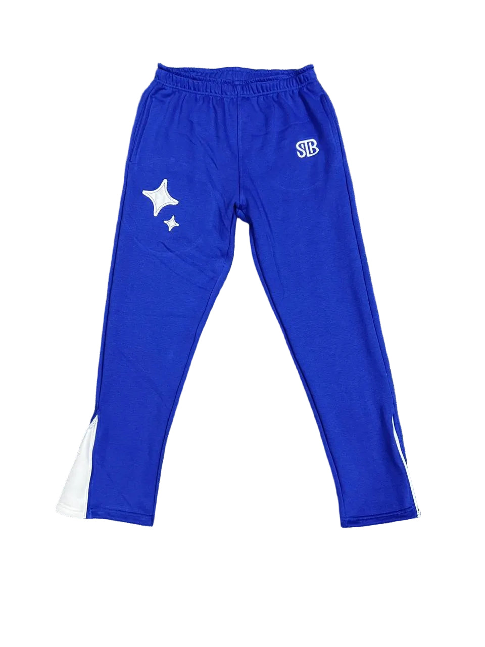 Blue tracksuit pants with a star design and logo on a grass background