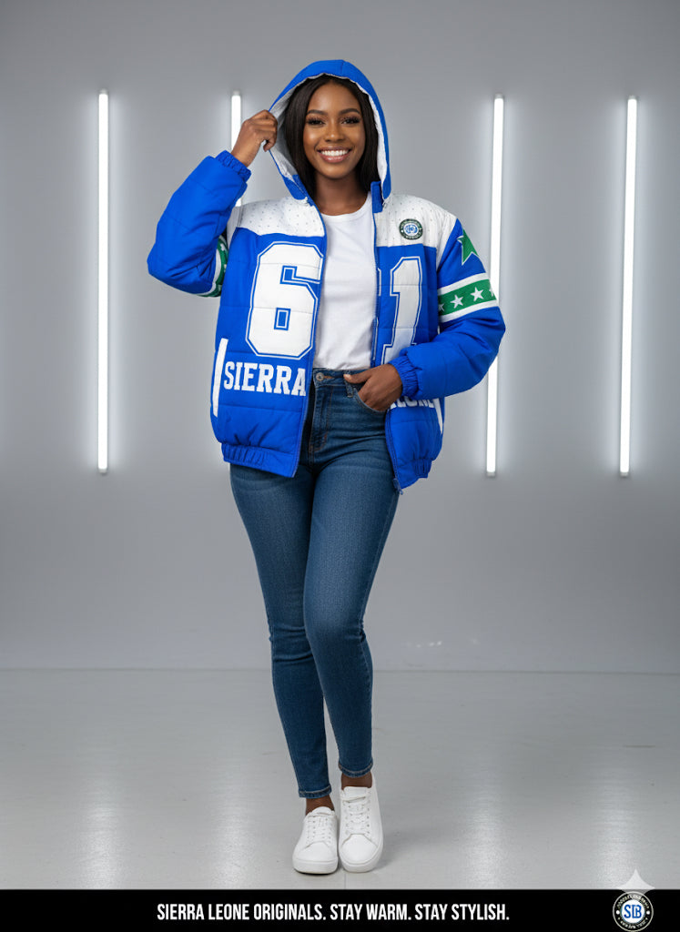 Woman wearing a blue and white jacket with visible branding against a gray background