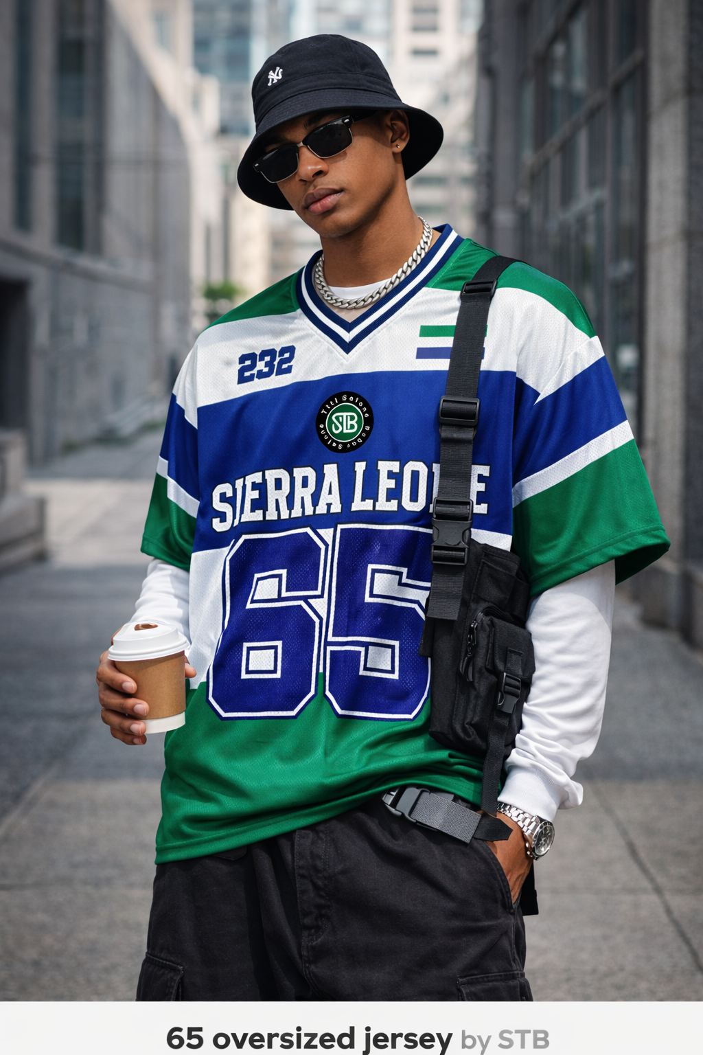 Man wearing a Sierra Leone jersey with the number 65, standing in an urban setting.