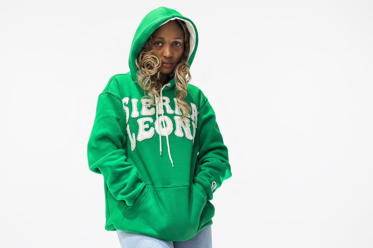 Female model  wearing a green Sierra Leone hoodie for a photoshoot 