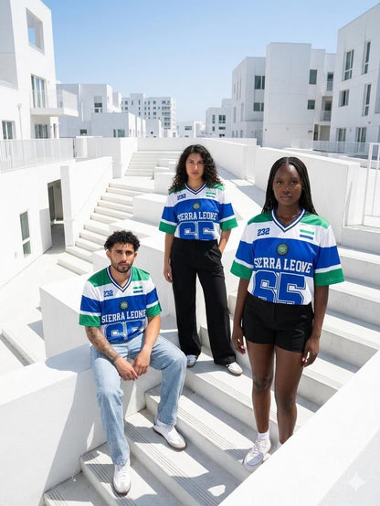 Three people wearing Serra Leone jerseys on a white architectural background