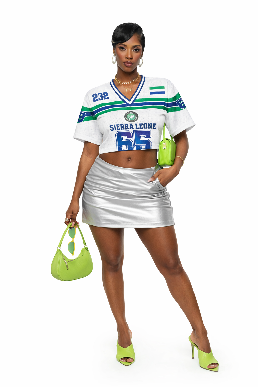 Woman wearing a Sierra Leone sports jersey with a silver skirt and green accessories on a white background