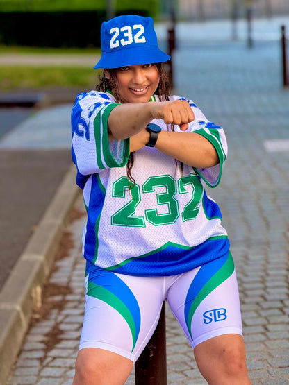 Person wearing a sports uniform with number 232 on a paved area